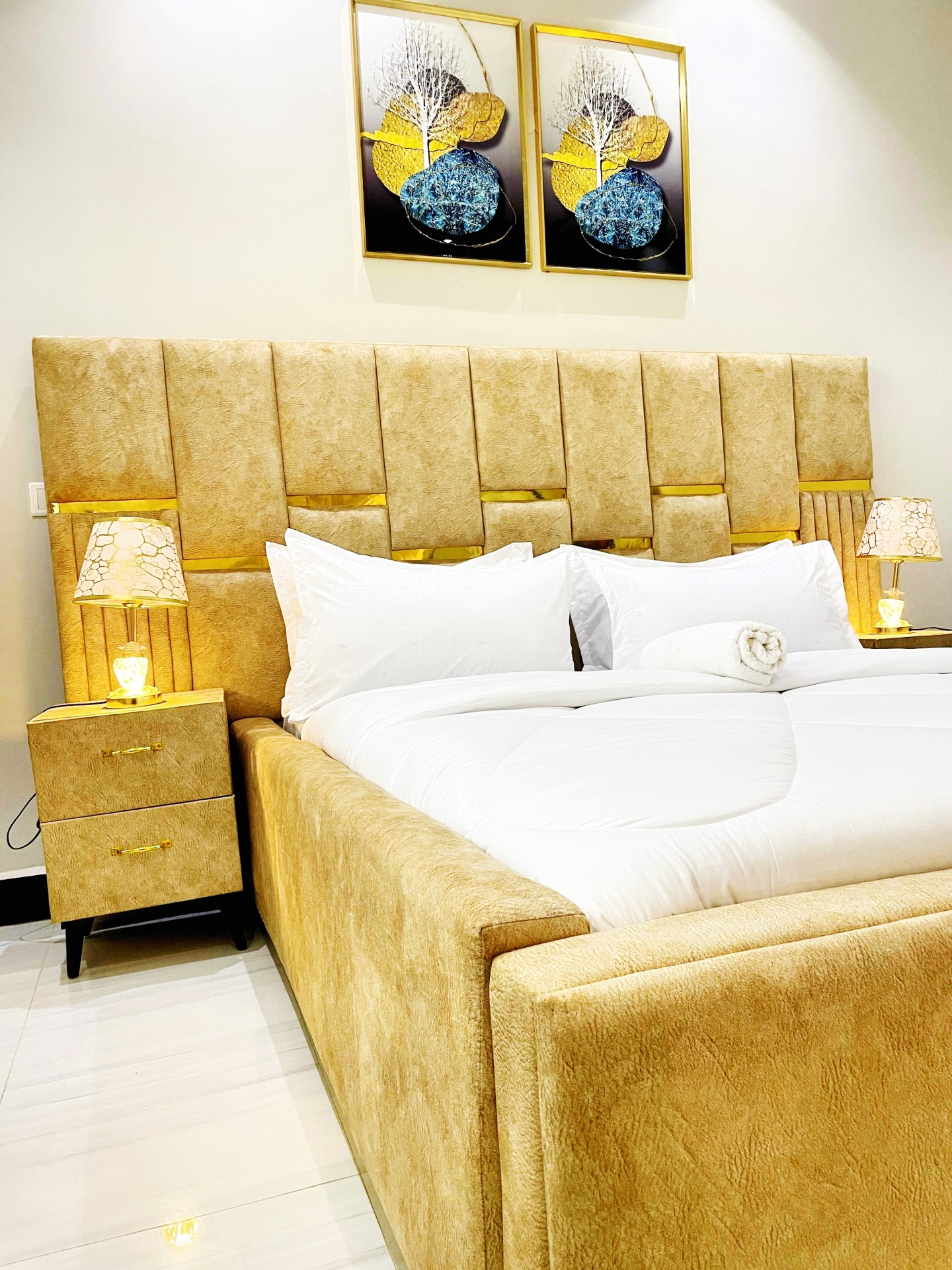 Gold-toned studio bedroom at SN Suites Apartments